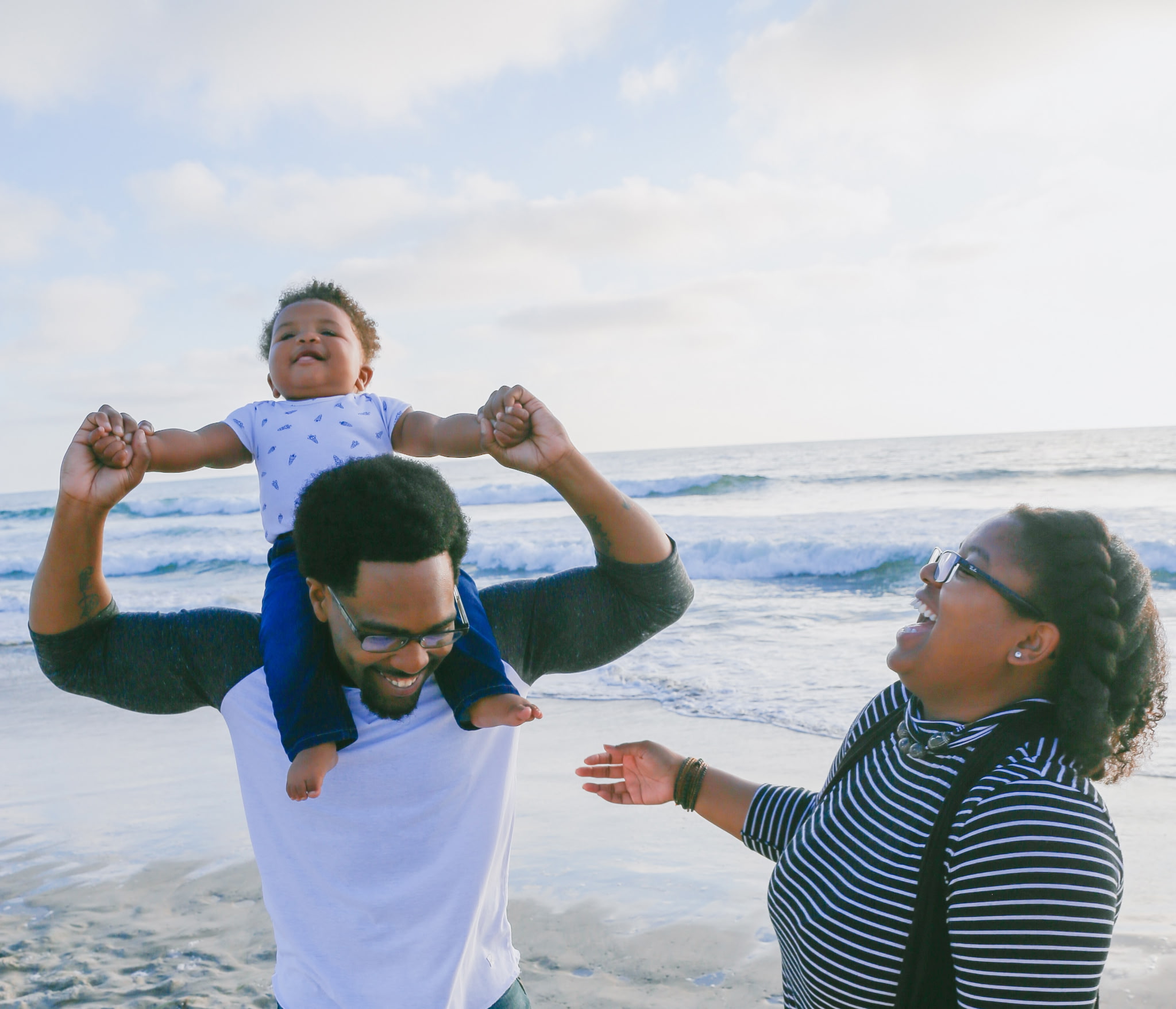 A family sharing a joyful moment together at the beach